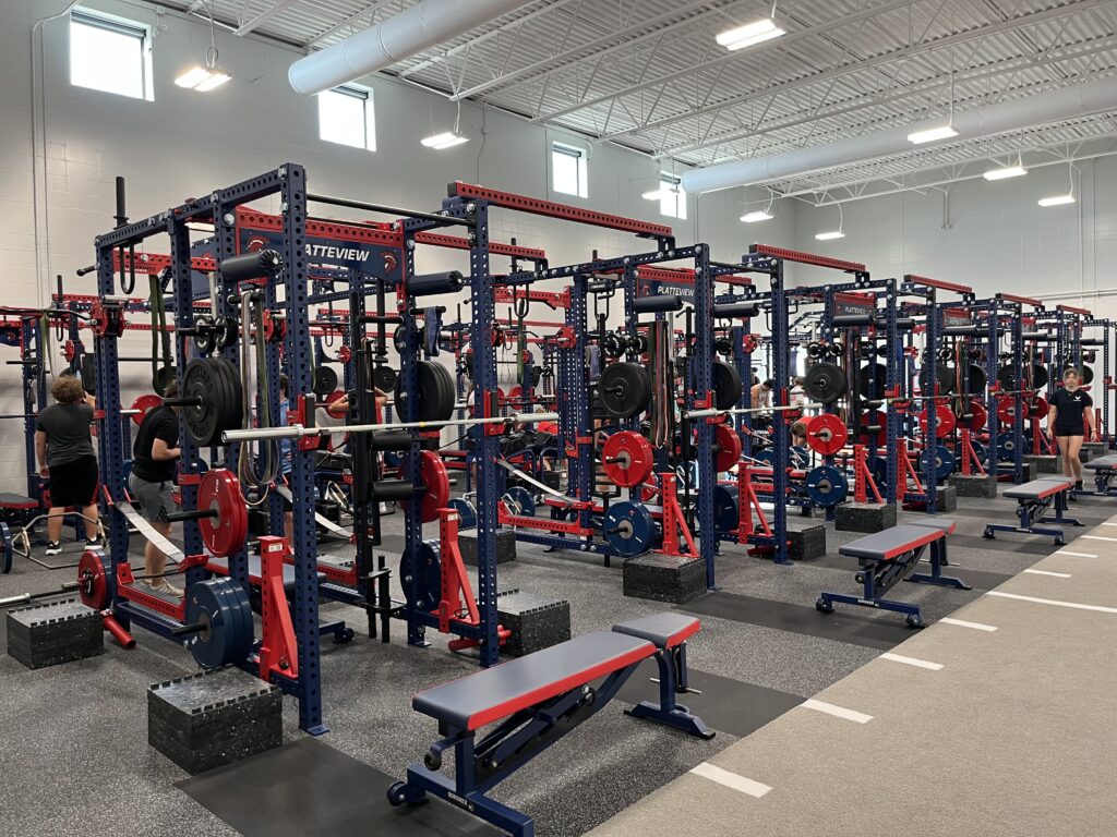 The strength and fitness center at Platteview high school with several weights showing in the picture as well as weight machines