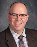 a picture of Dr RYAN Saunders who is the superintendent of the Springfield Platteview community school District