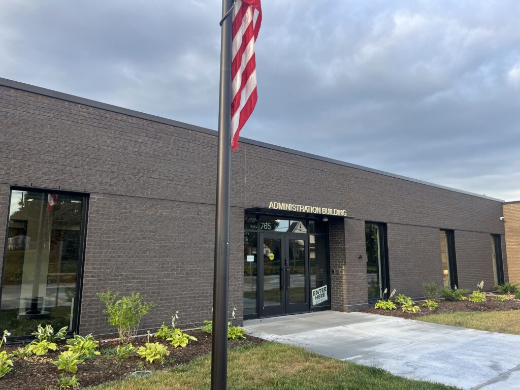 the front of the Springfield Platteview Administration Building. These two words are above the door that has the 765 numbers on it for the address.