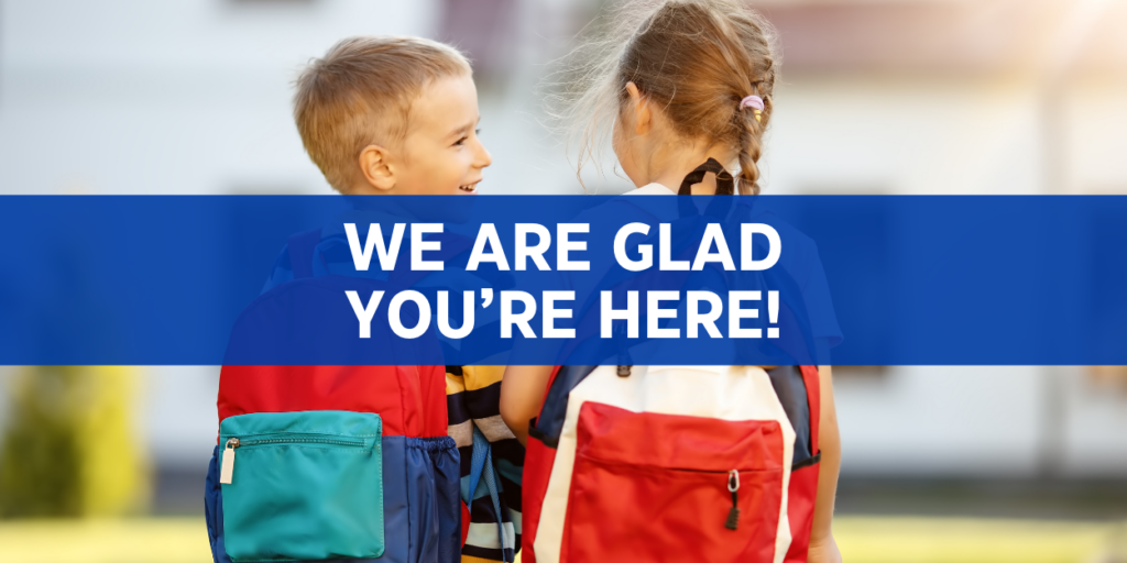 two young students walking with the words we are glad you're here on the image